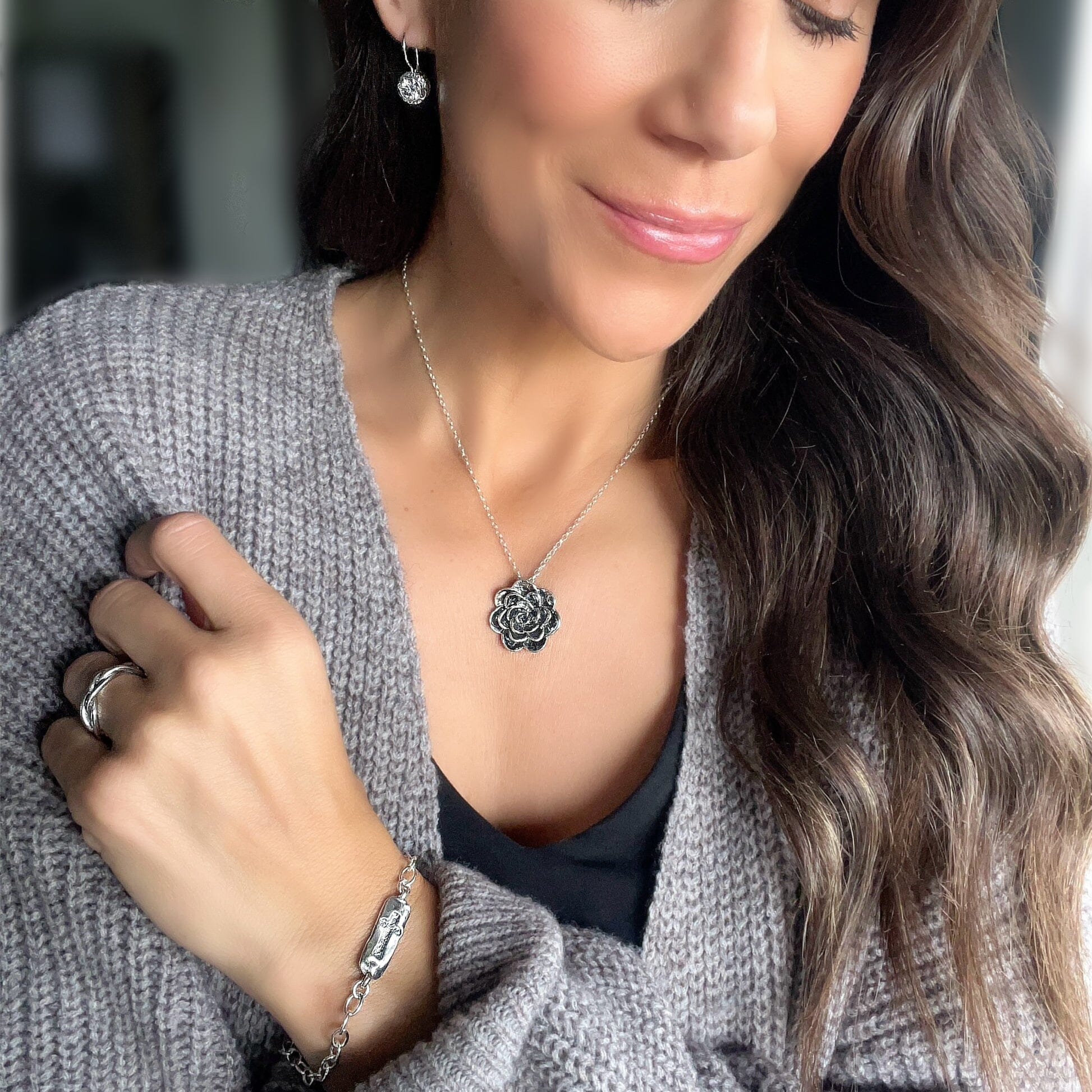 .925 silver Camellia necklace paired with the Plot twist ring, intrigue earrings and The One bracelet