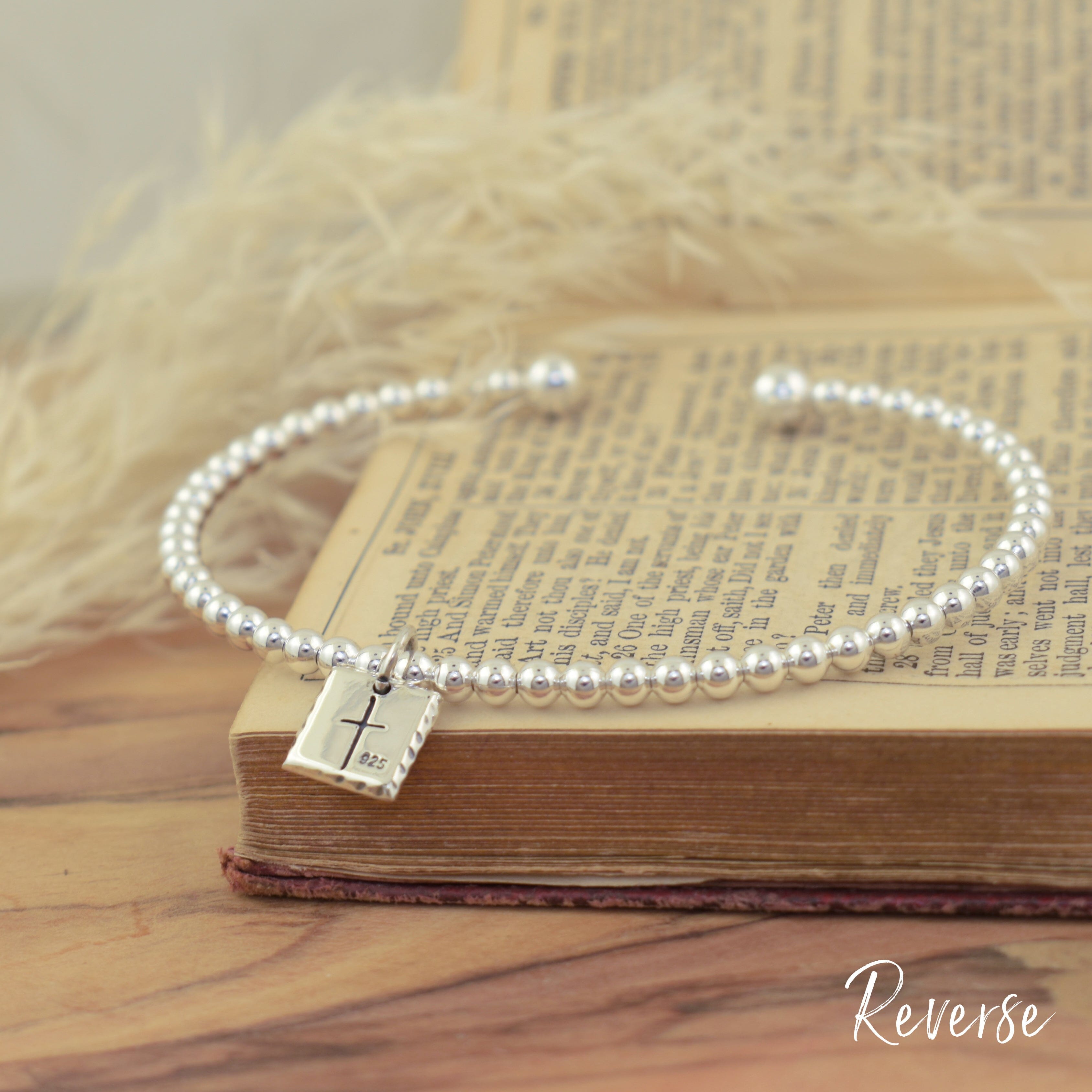 engraved 41 cuff bracelet in sterling silver with a cross on the back of the pendant