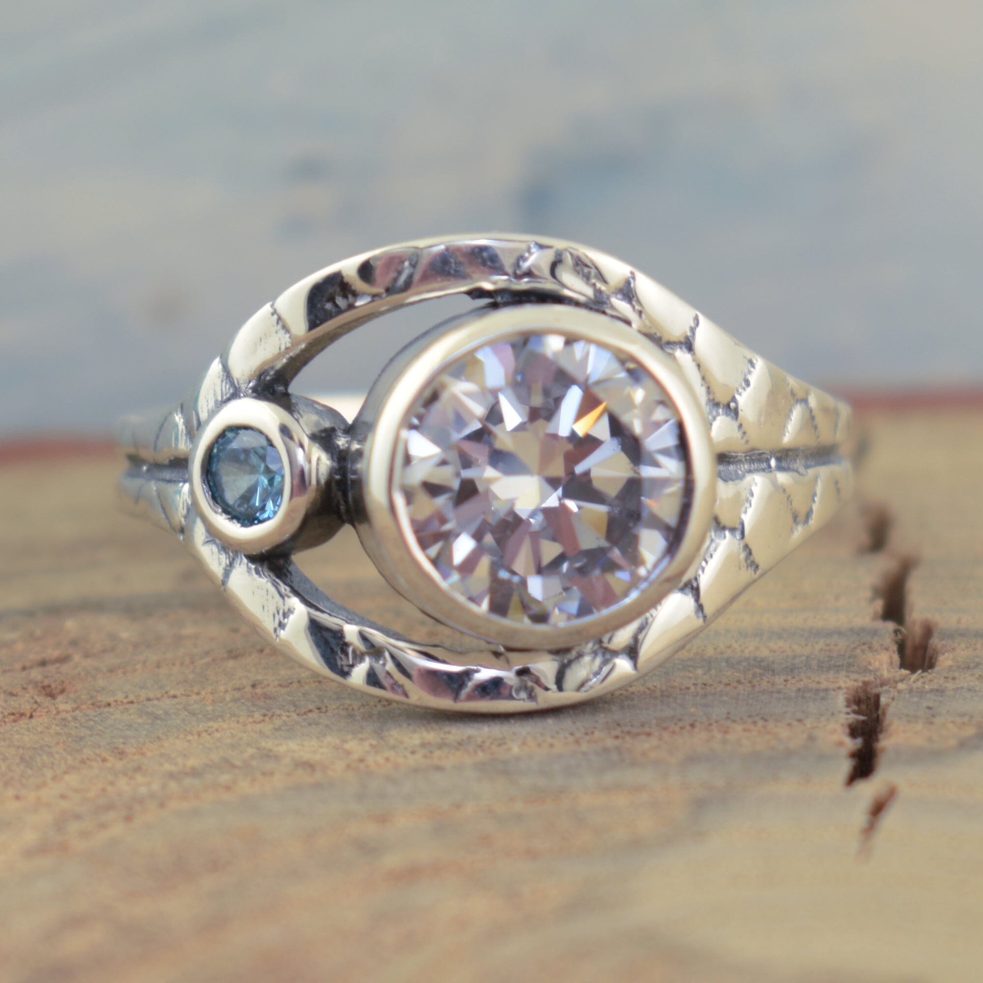 .925 sterling silver textured band ring with large round cubic zirconia stone and small blue topaz cubic zirconia stone