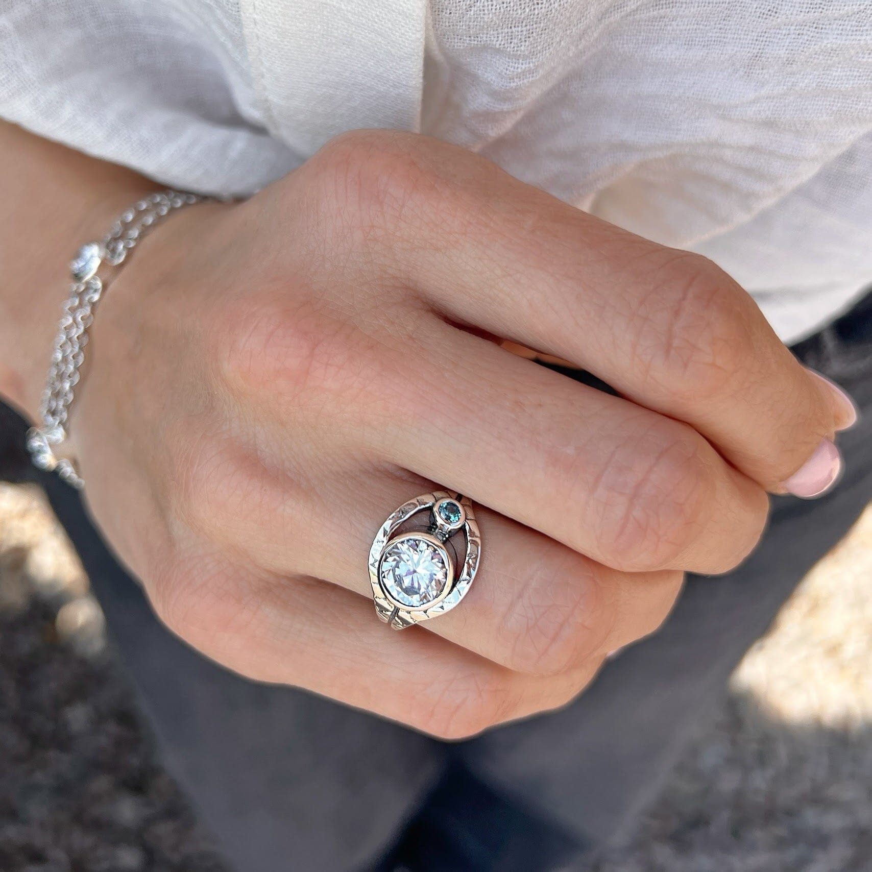 unique sterling silver ring featuring clear and blue cubic zirconia stones