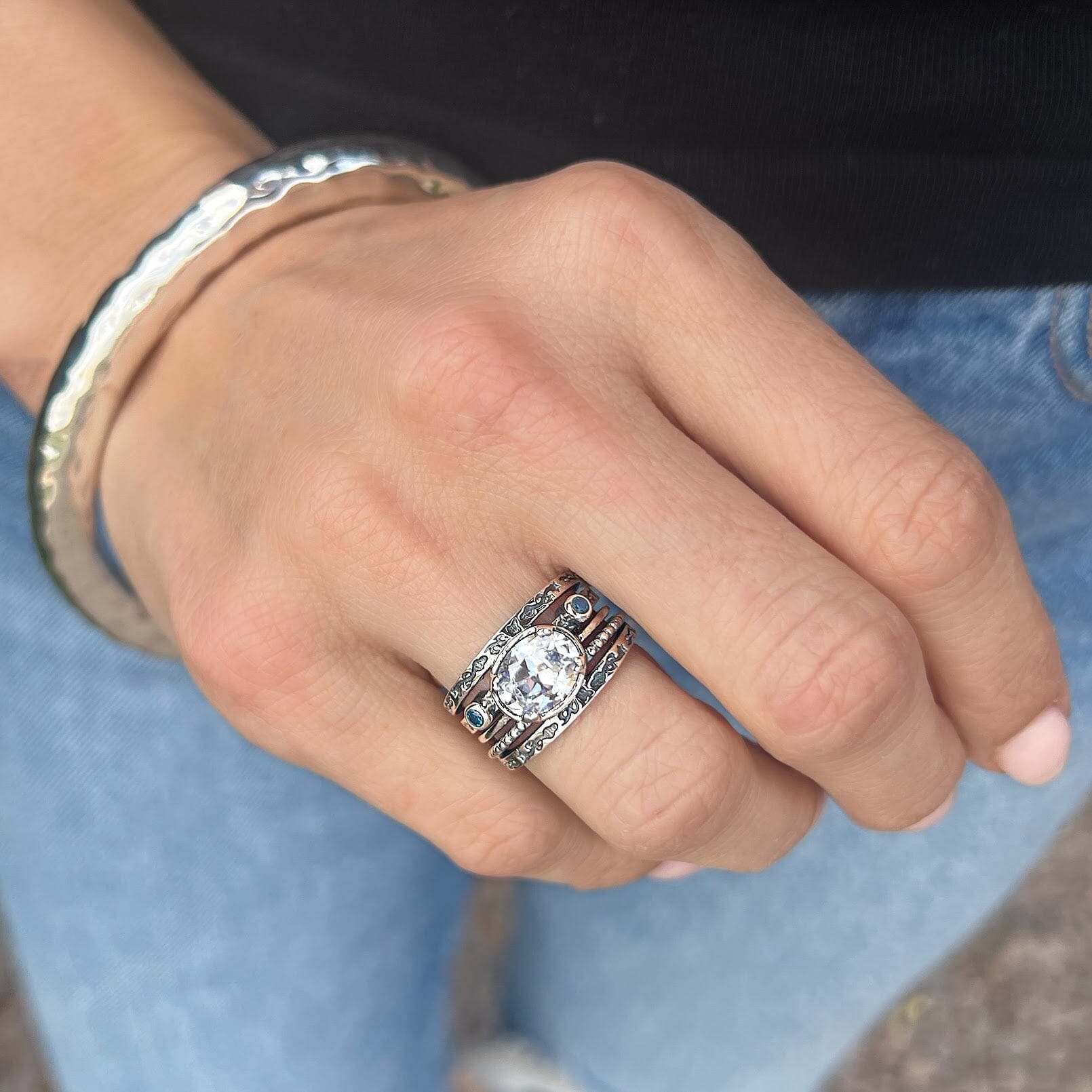 beach style ring featuring a large oval clear cz and two small blue cz stones