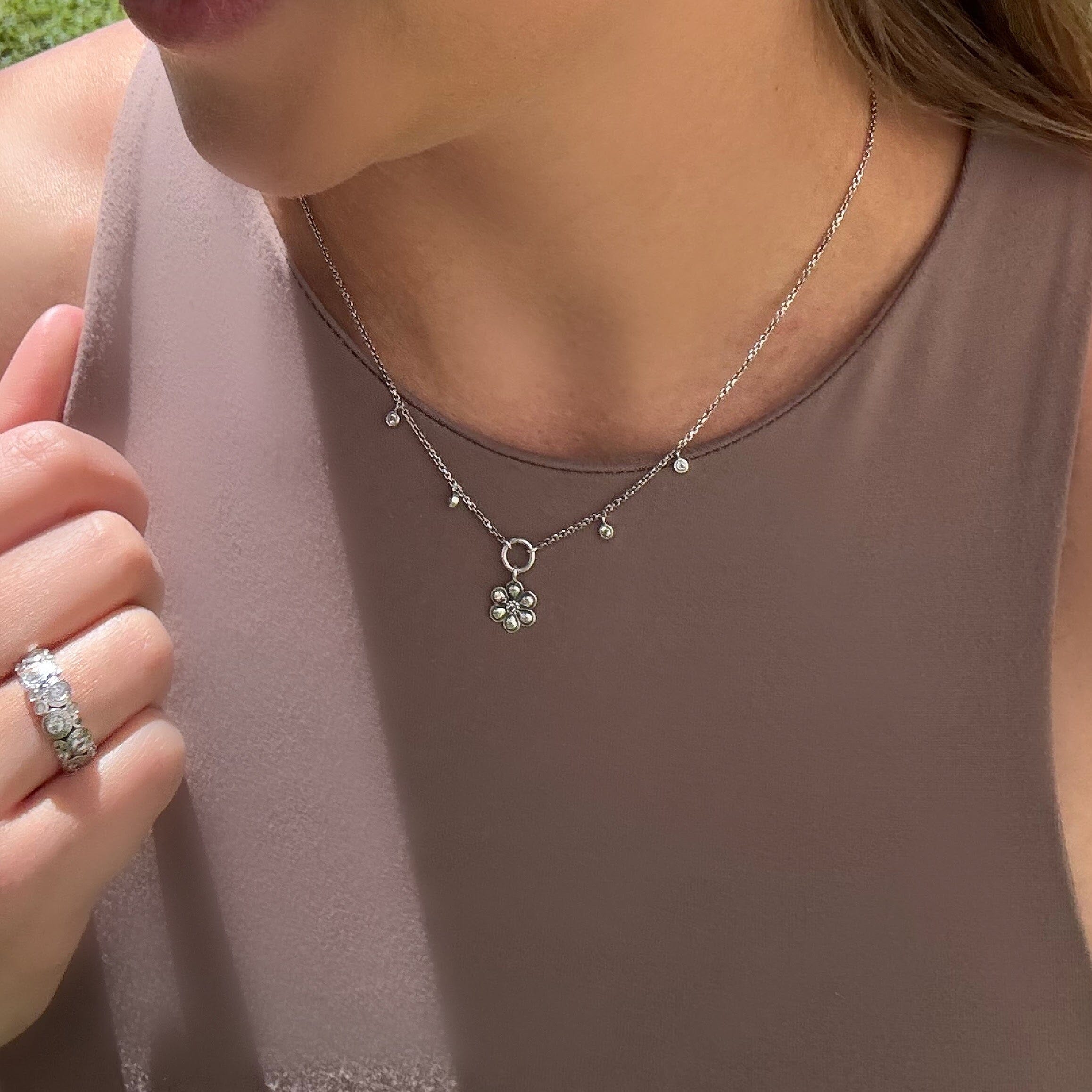 sterling silver six petal flower necklace with 4 CZ stones hung on the sides