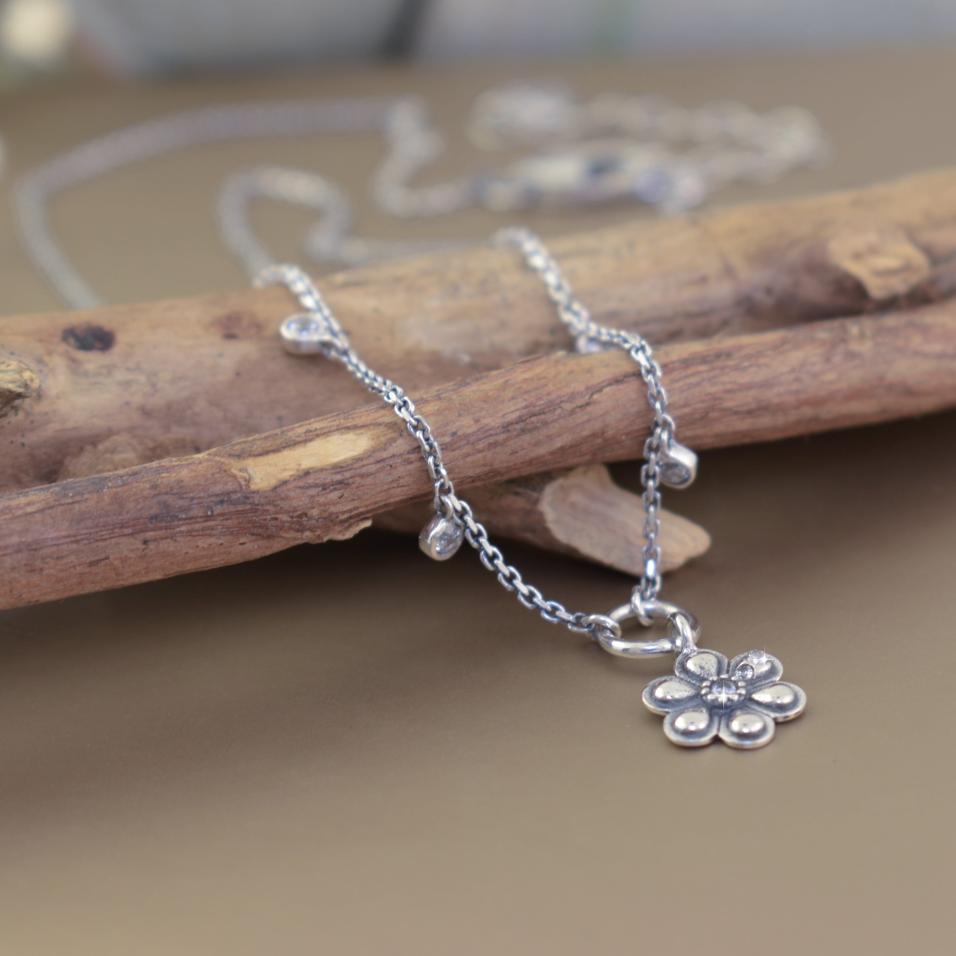 delicate flower necklace featuring 7 round CZ stones