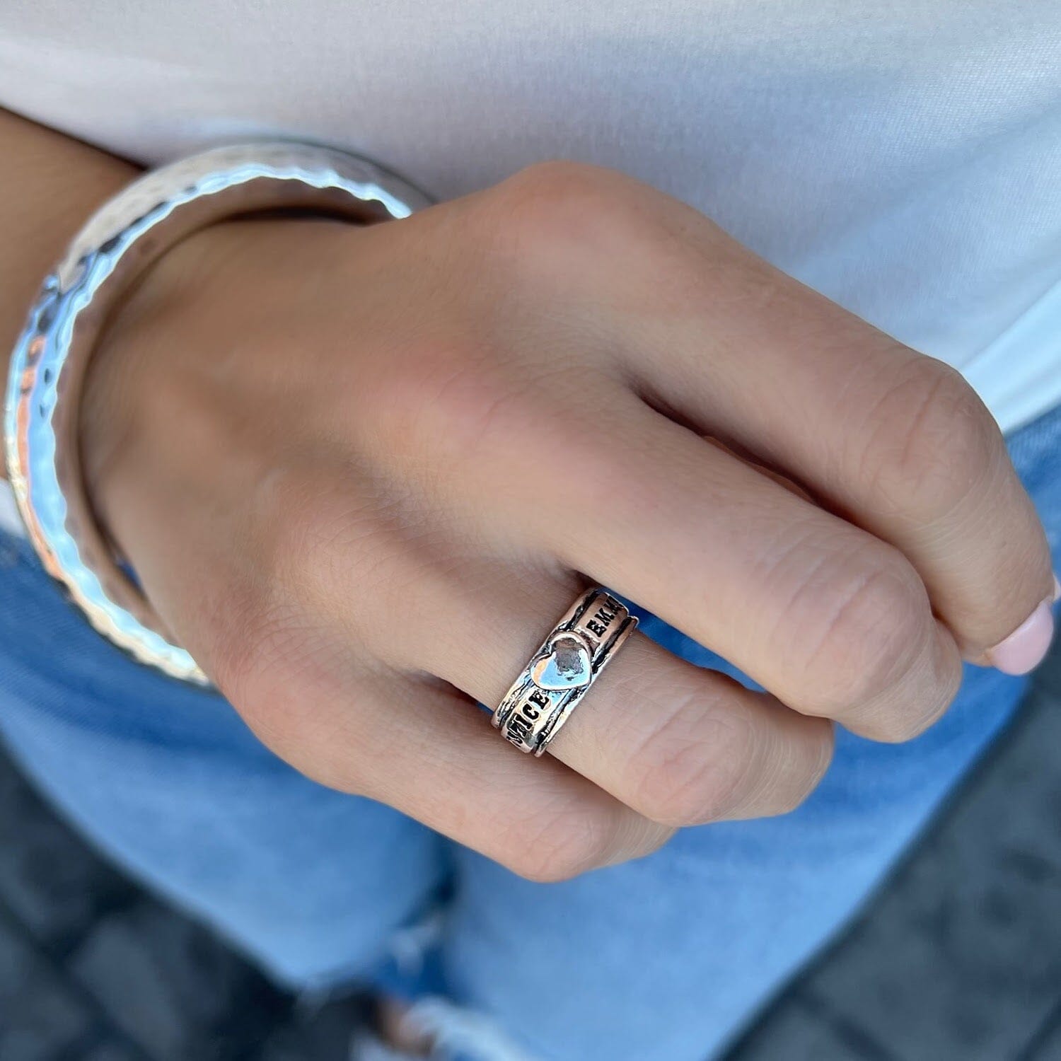 thin personalized ring with a silver heart center