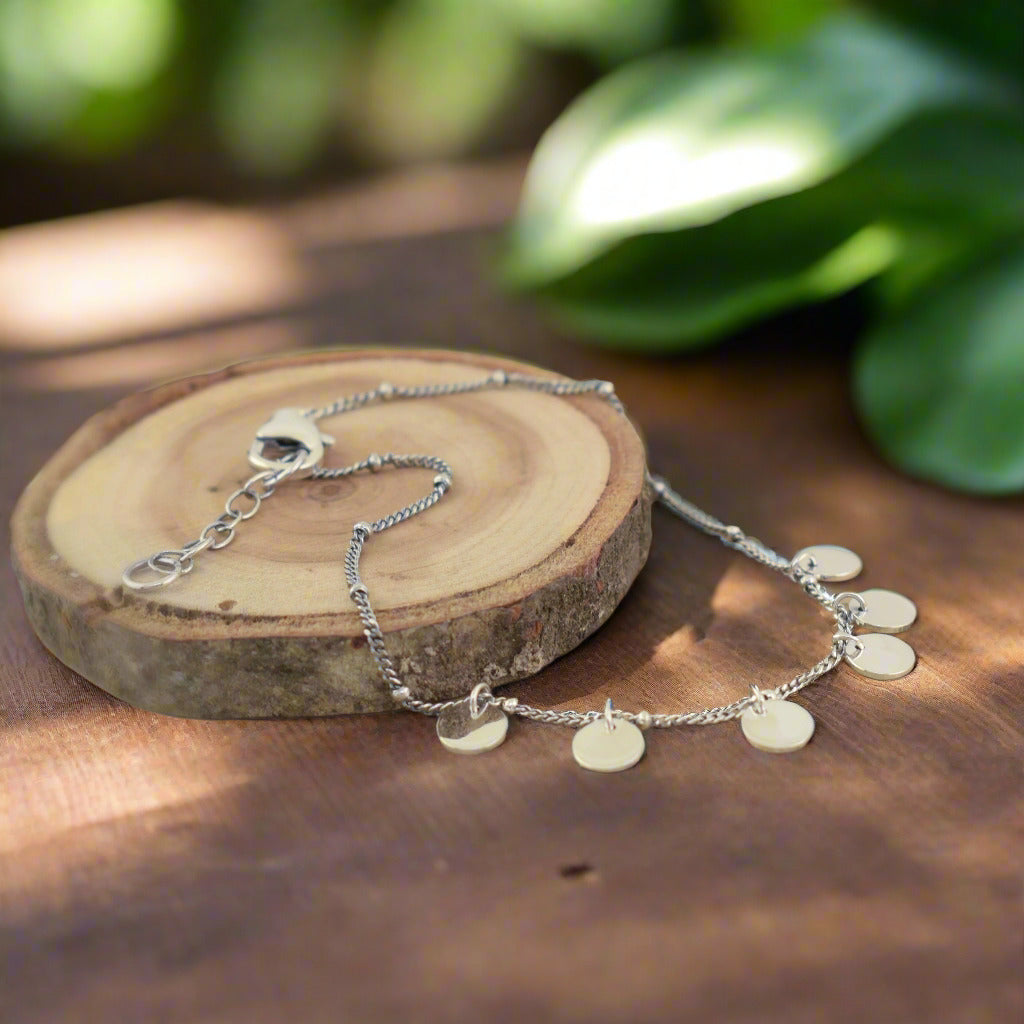 Handcrafted streling silver bracelet featuring high polished circular dangling elements