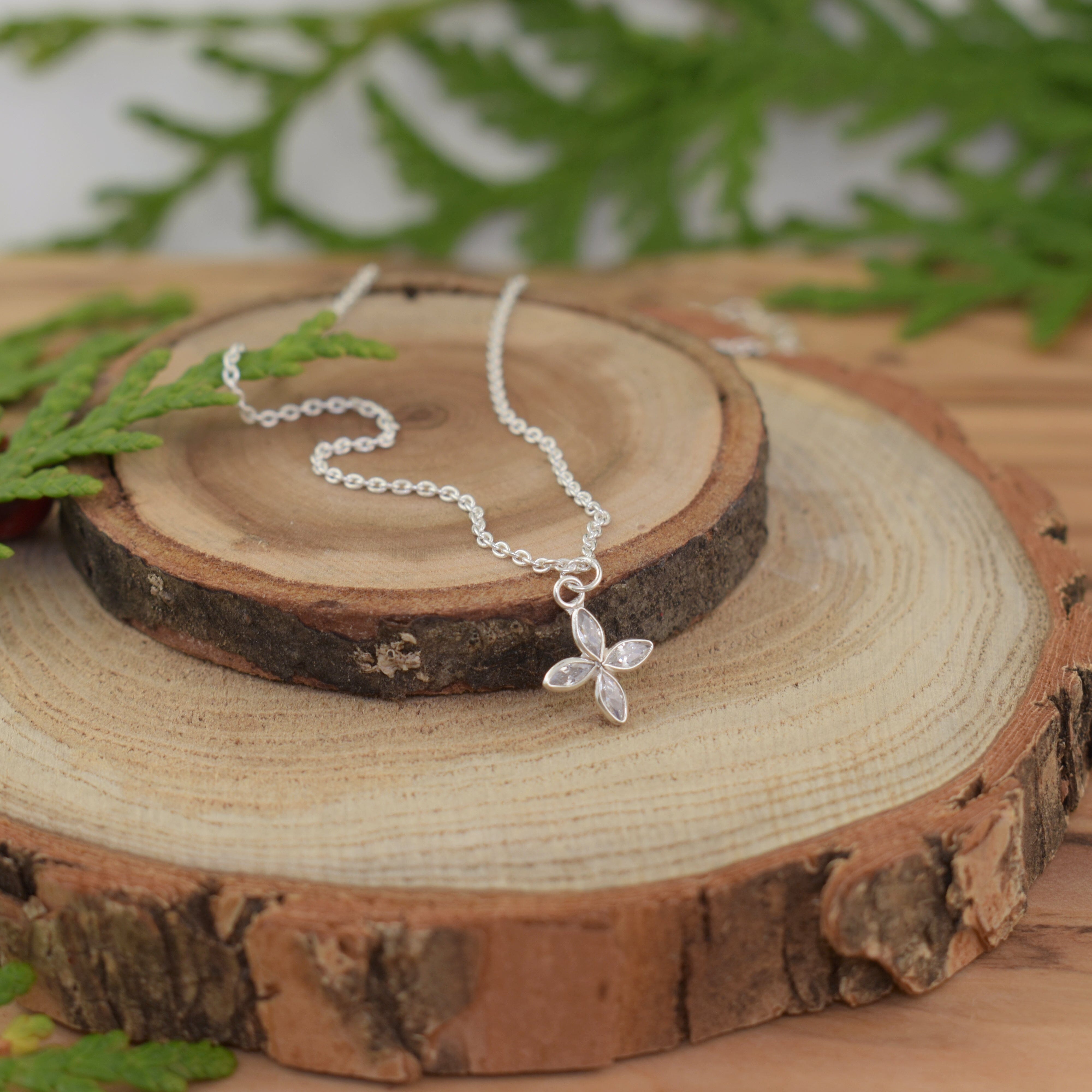 delicate silver necklace with a dainty flower cz pendant