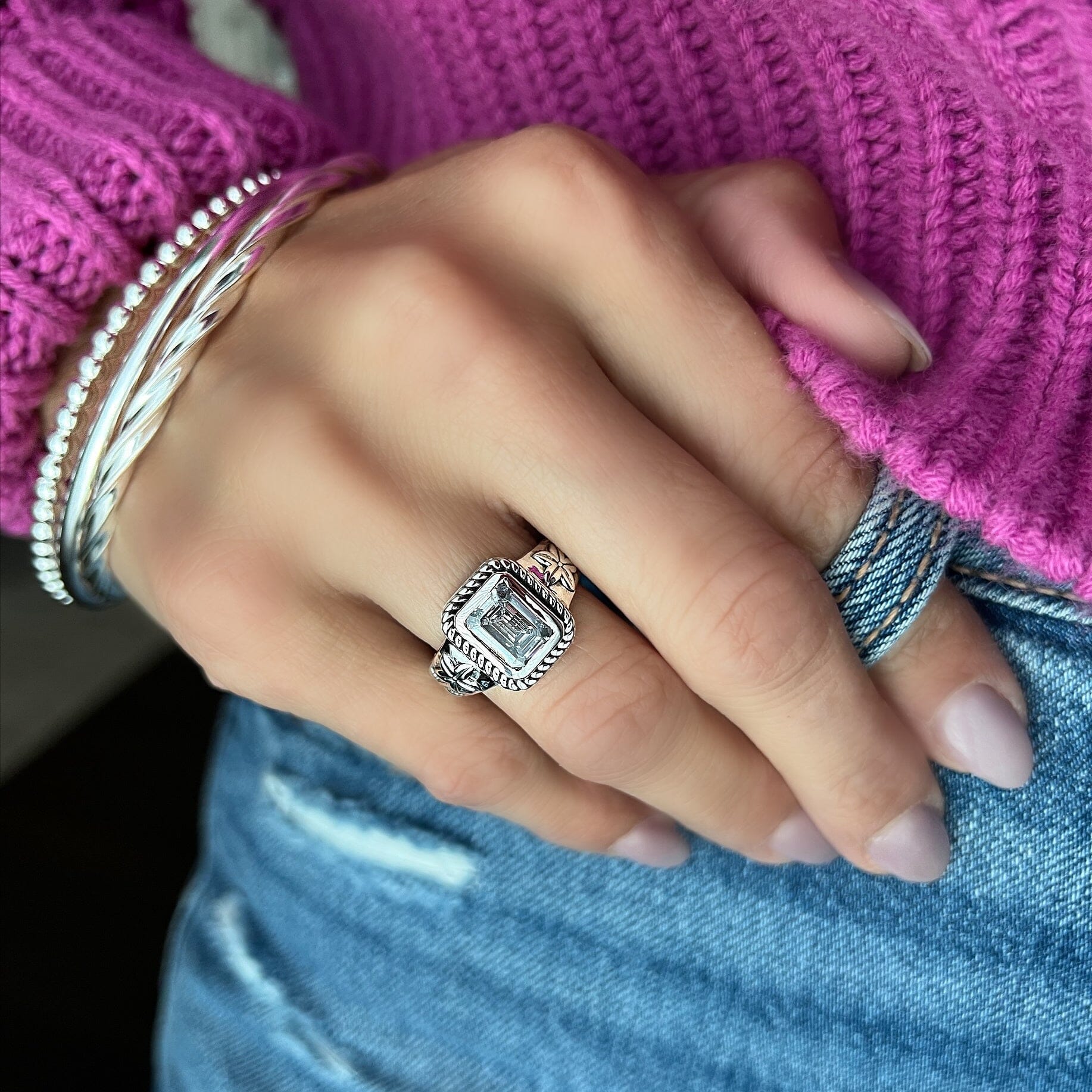 elegant framed emerald cut CZ stone with flower details on the band