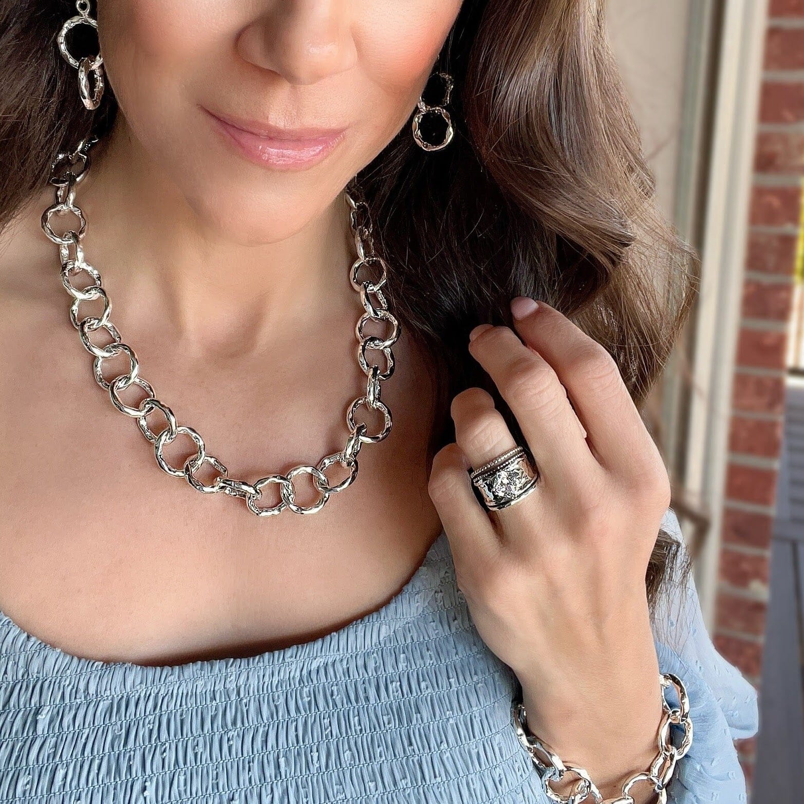 Grandstand Ring paired with silver hammered jewelry