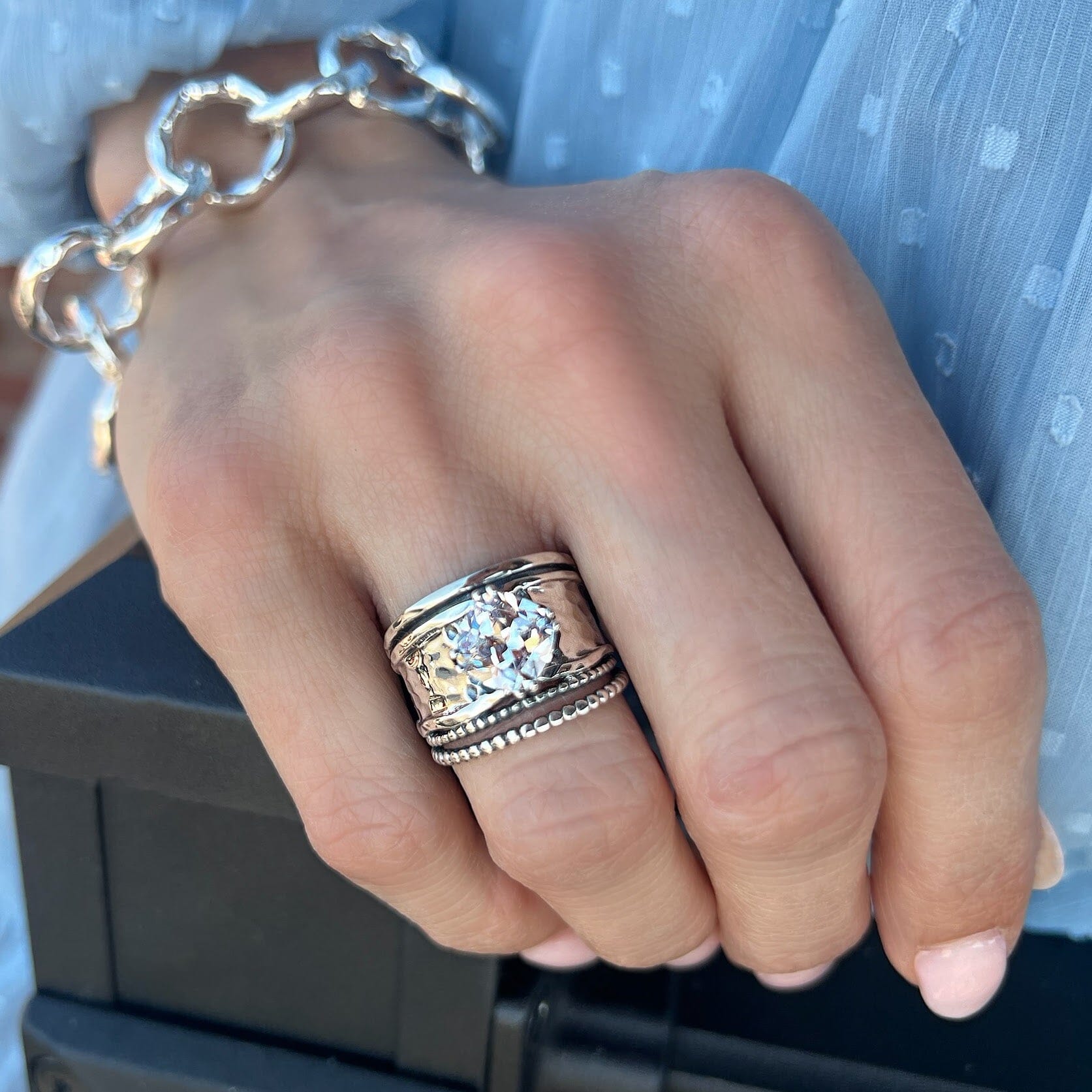 wide hammered silver ring featuring a square prong-set CZ stone