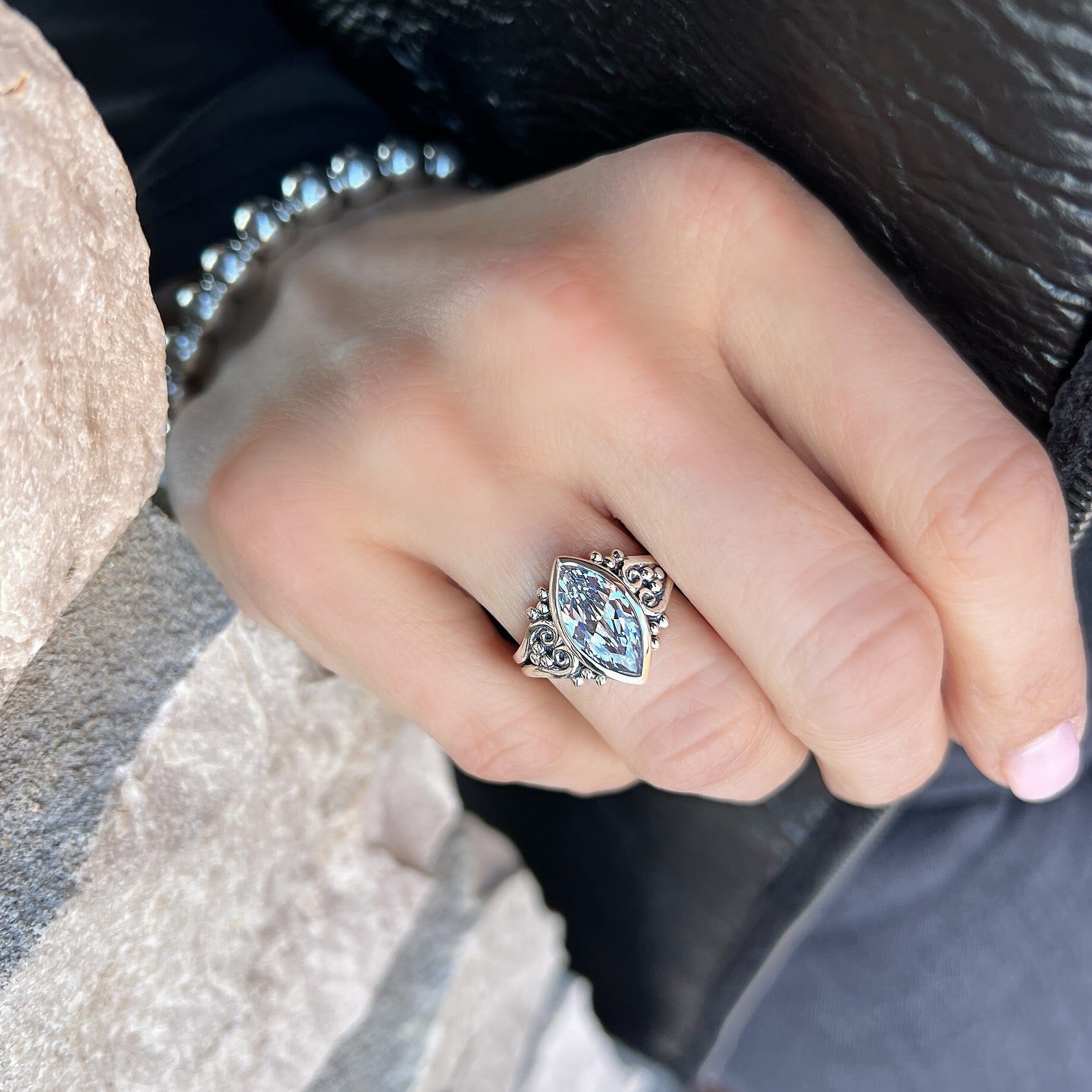 sterling silver ring with a detailed band with sliver beads around the stone