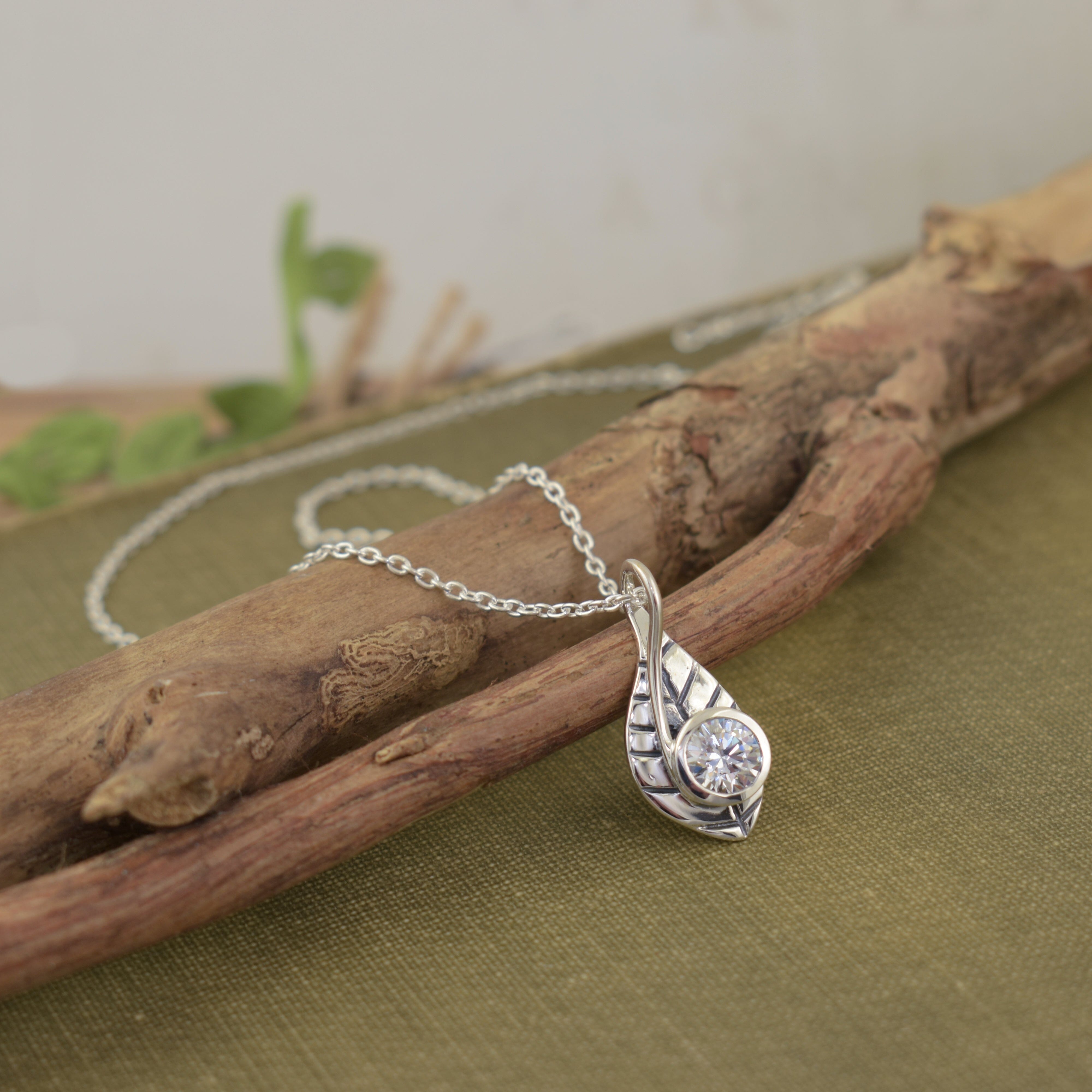 delicate leaf necklace featuring a clear cz at the bottom