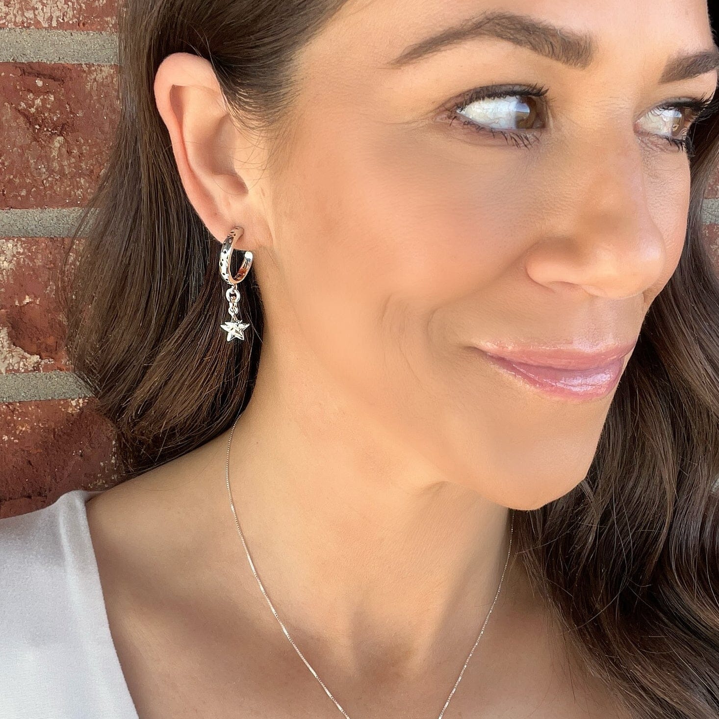dainty hoop earrings featuring two overlapping star dangles in sterling silver