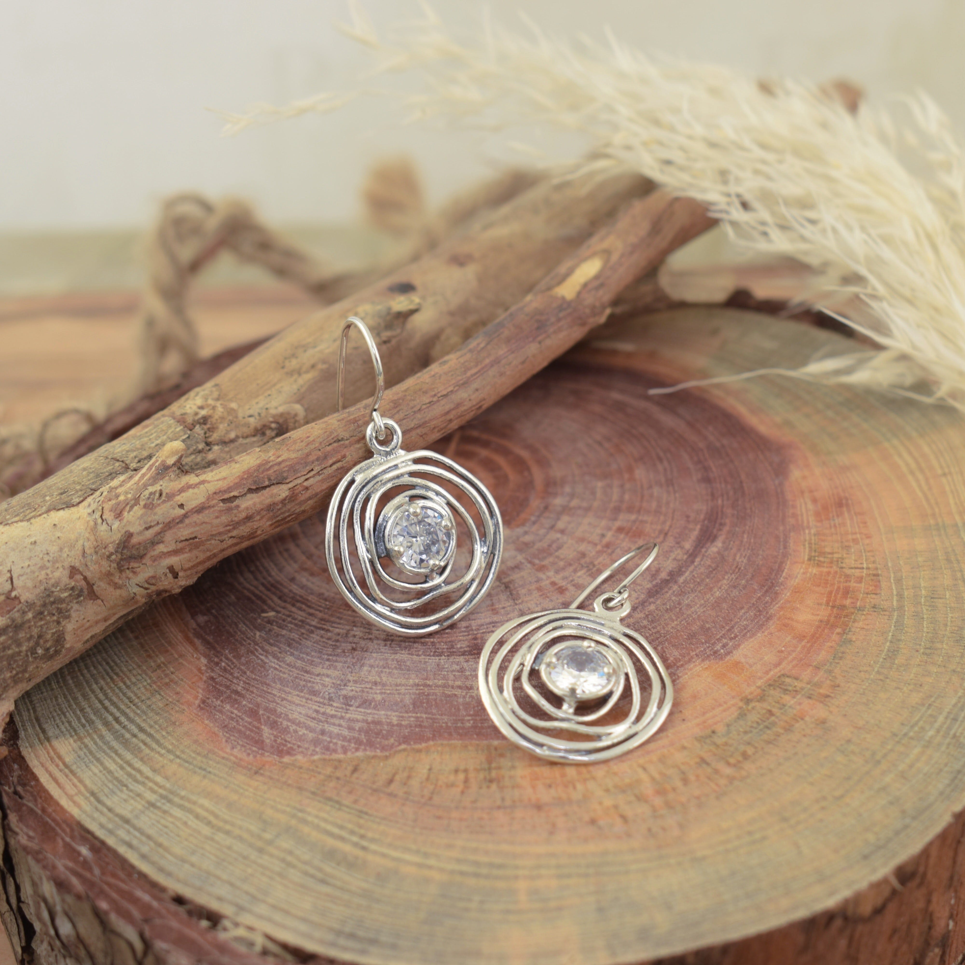 Organic sterling silver designer earrings with round cubic zirconia center