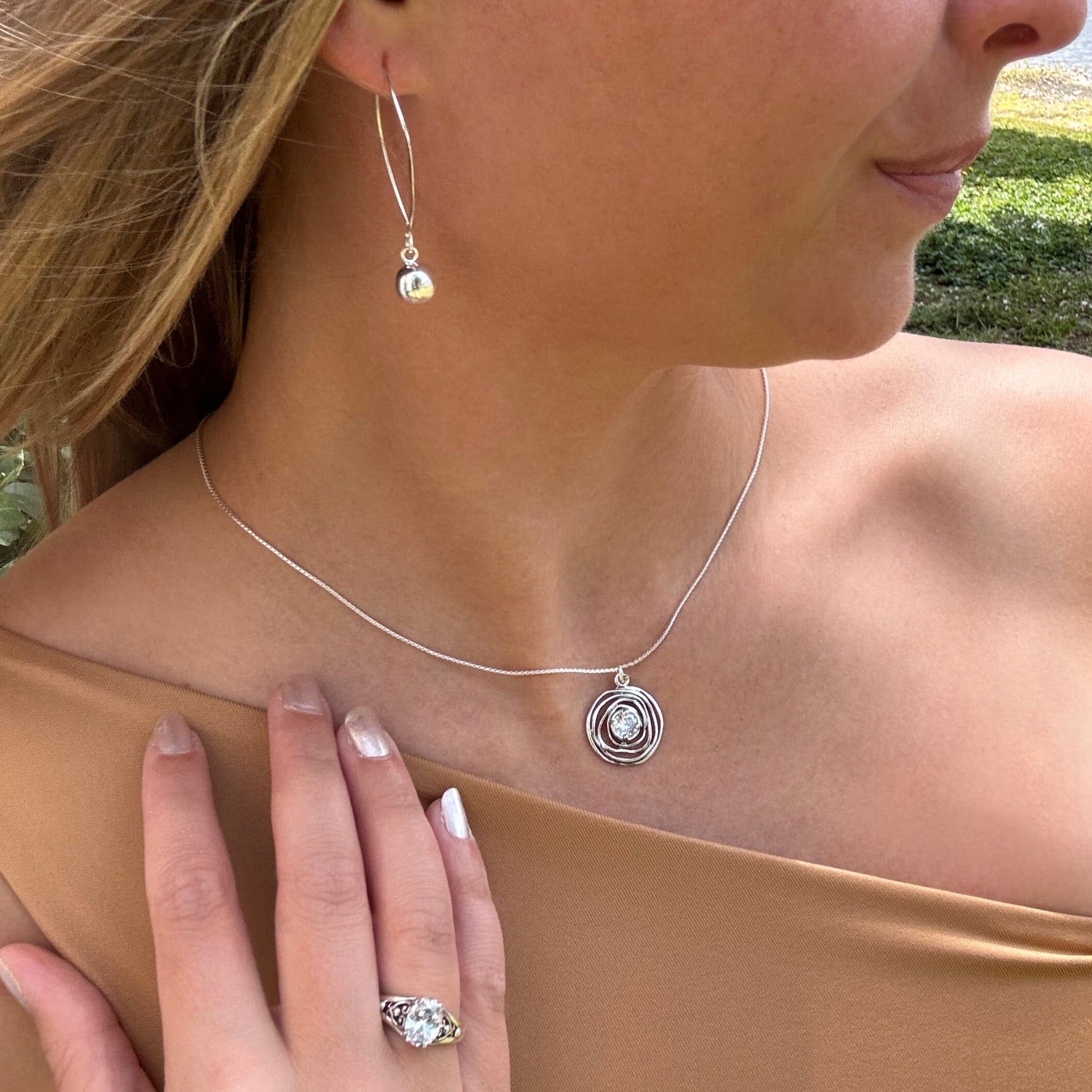silver organic wavy pendant featuring a prong-set cz center on a sleek silver chain