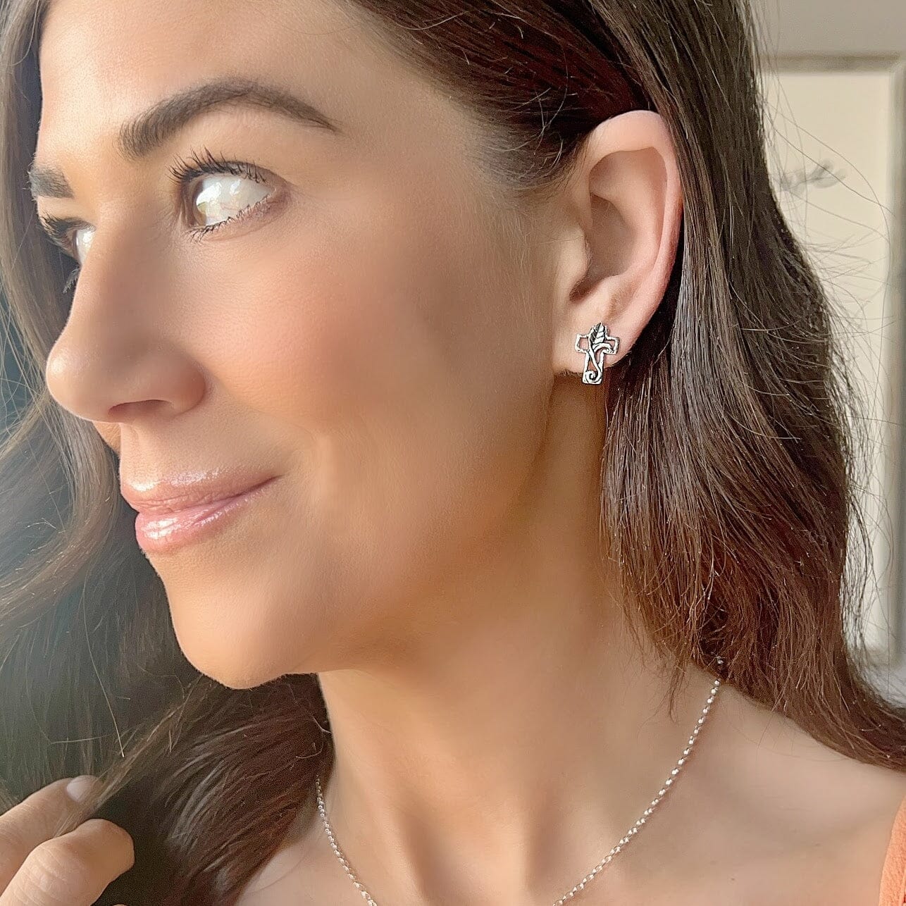 cross shaped push-back post style earrings in sterling silver with a leaf design