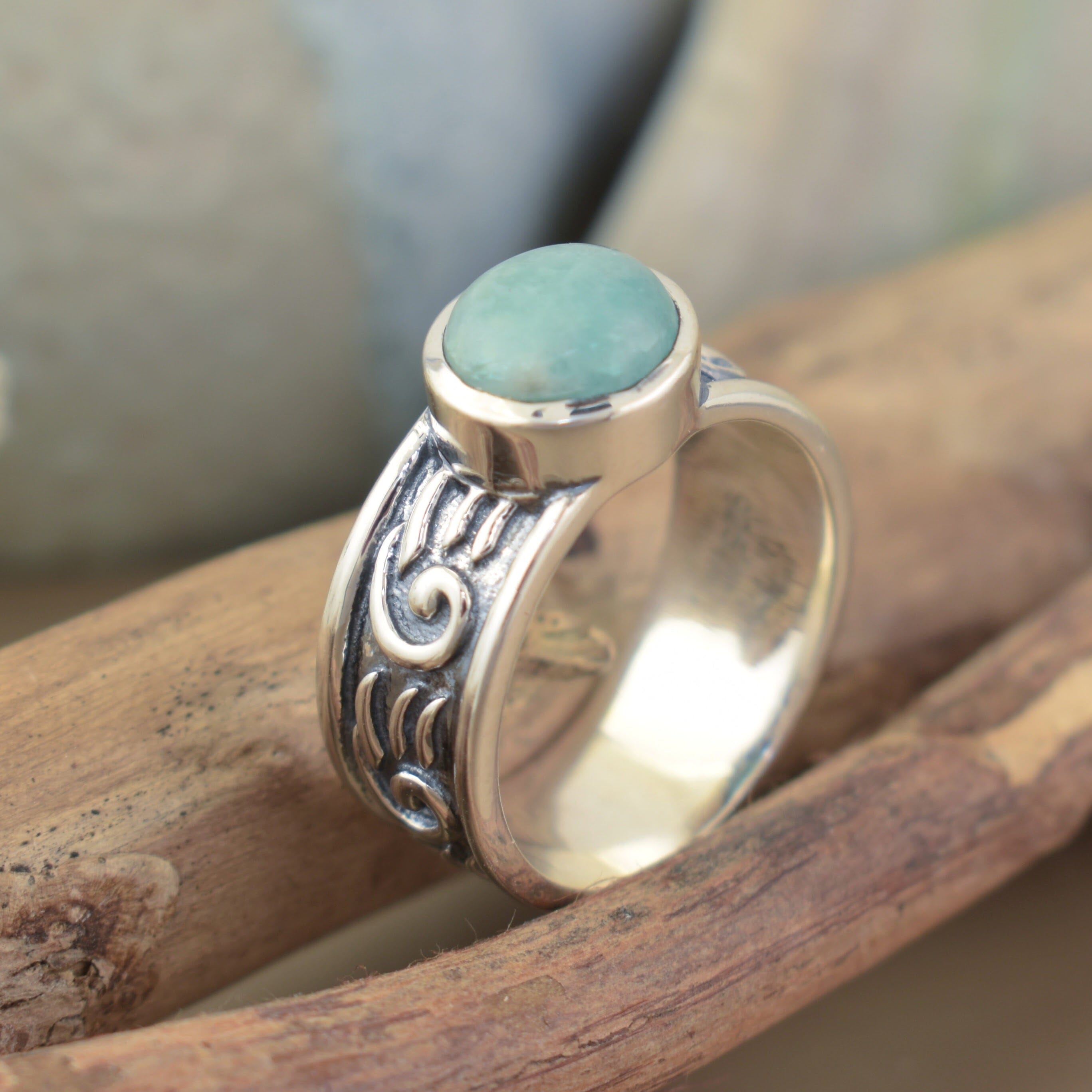 sterling silver ring featuring an oxidized finish with high polished details and a round amazonite stone