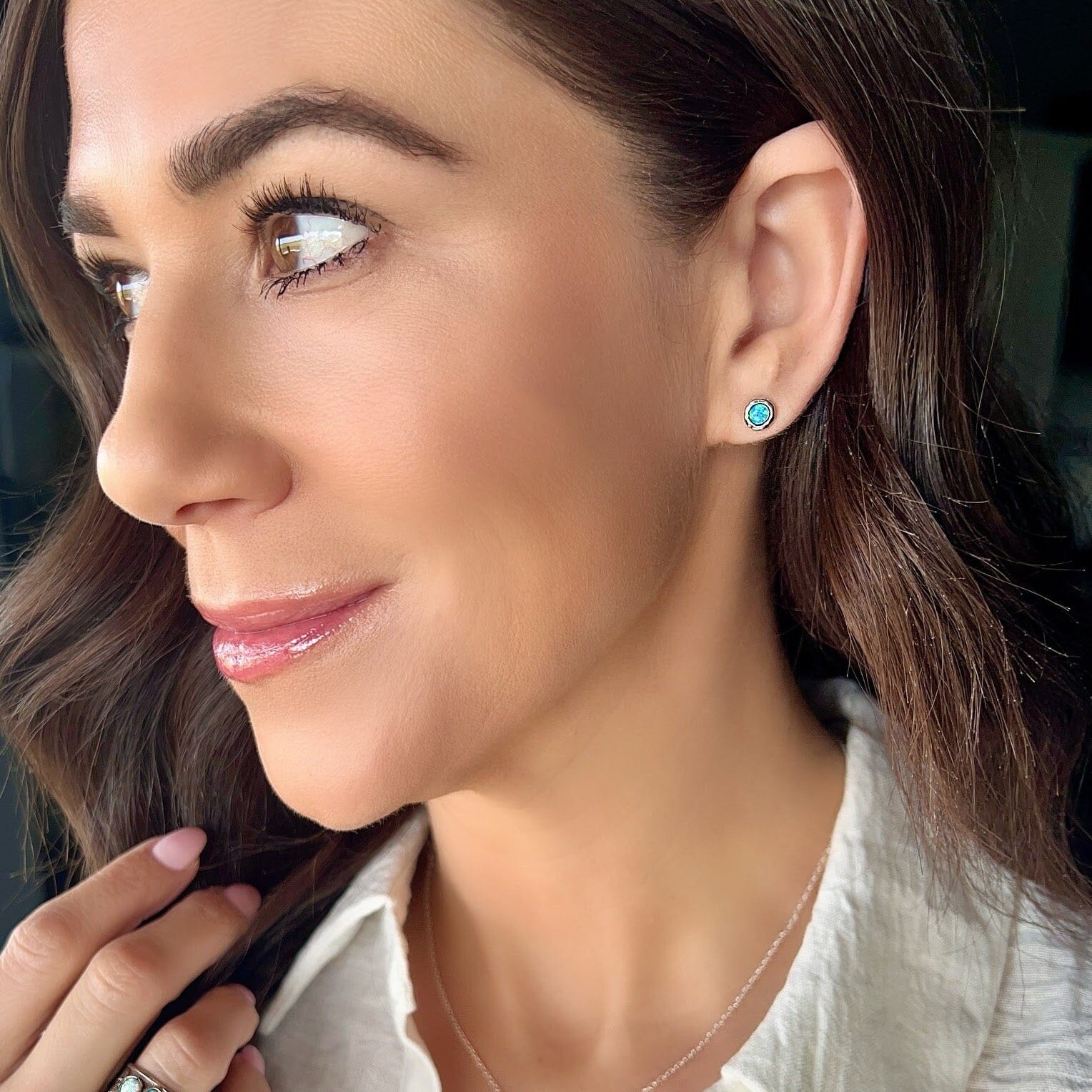 small push-back post earrings featuring round reconstructed opal