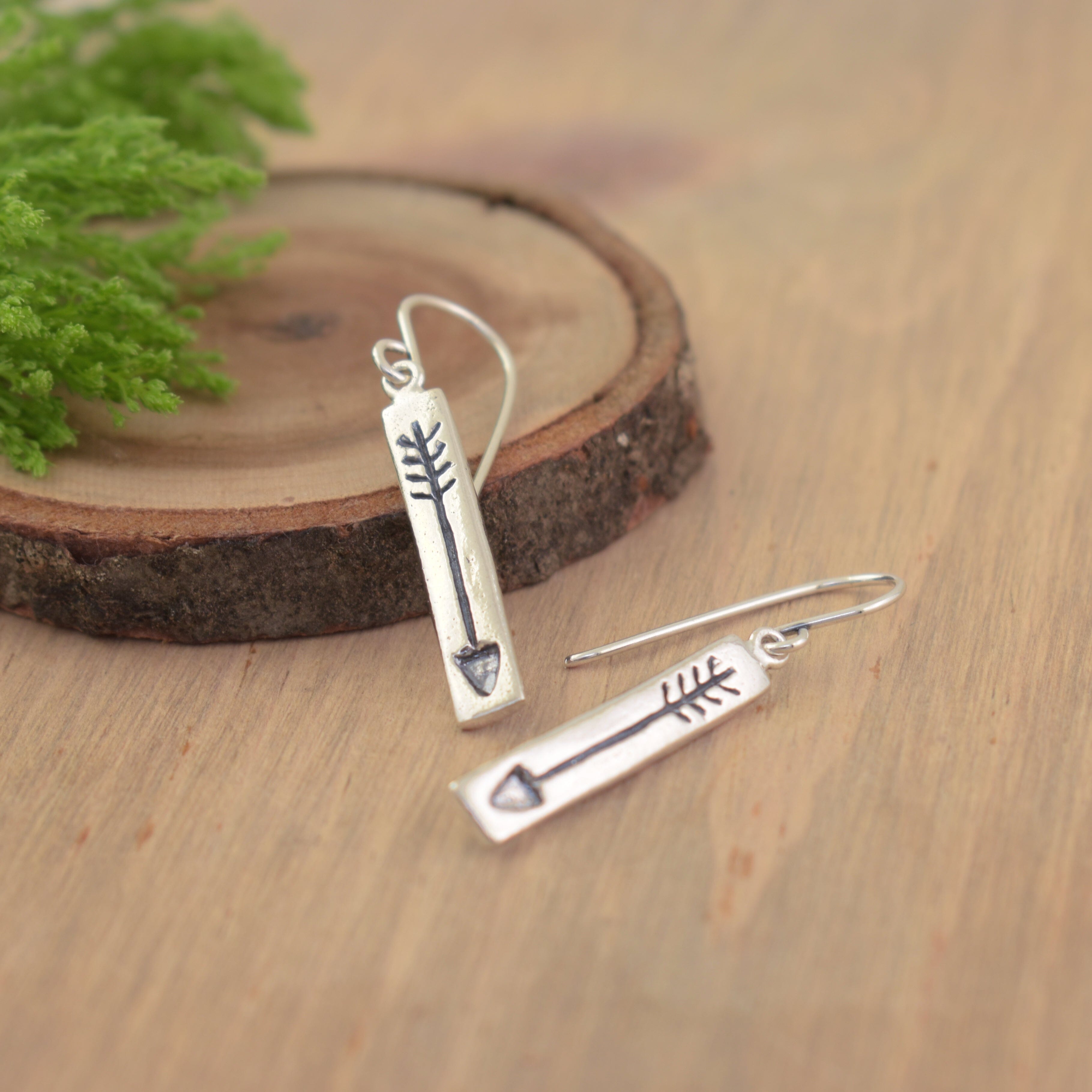 silver dangling hook earrings featuring a silver bar pendant with a hand-stamped arrow