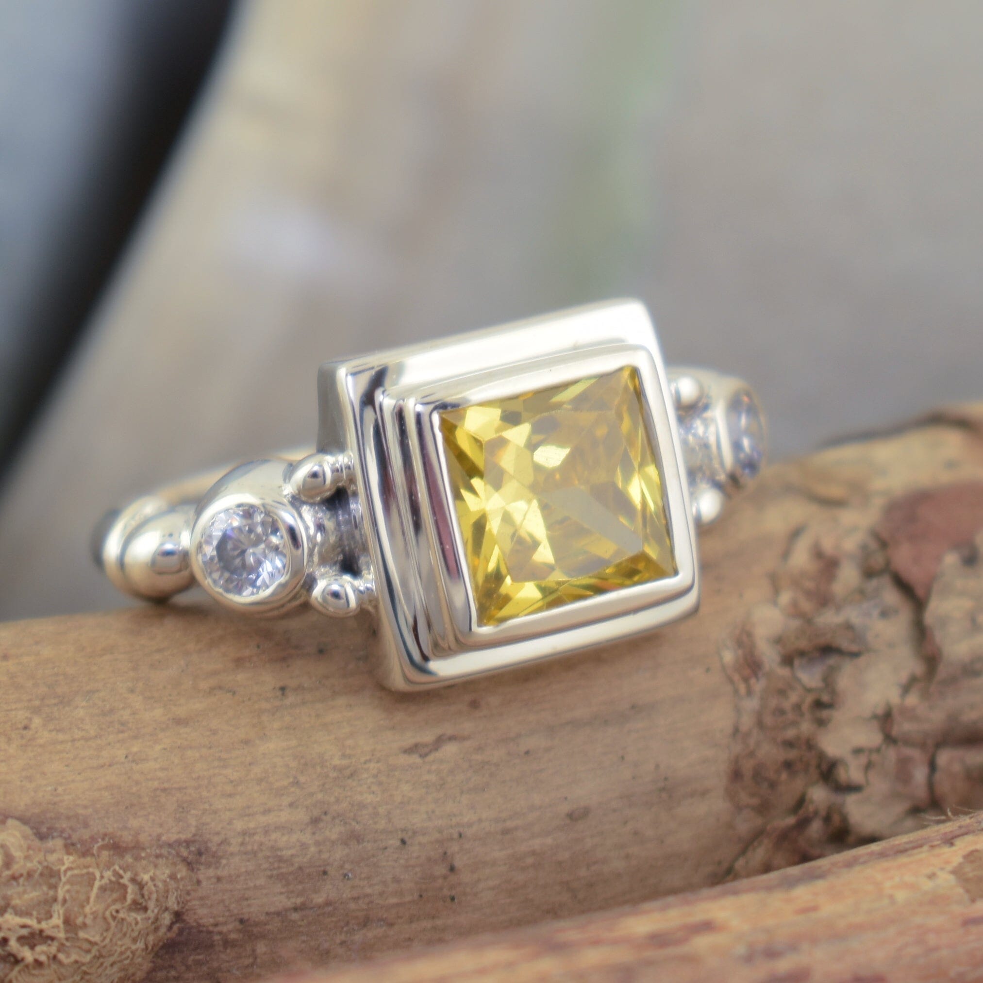 princess cut saffron yellow cz bezel set in handcrafted sterling silver featuring a round cz stone on each side