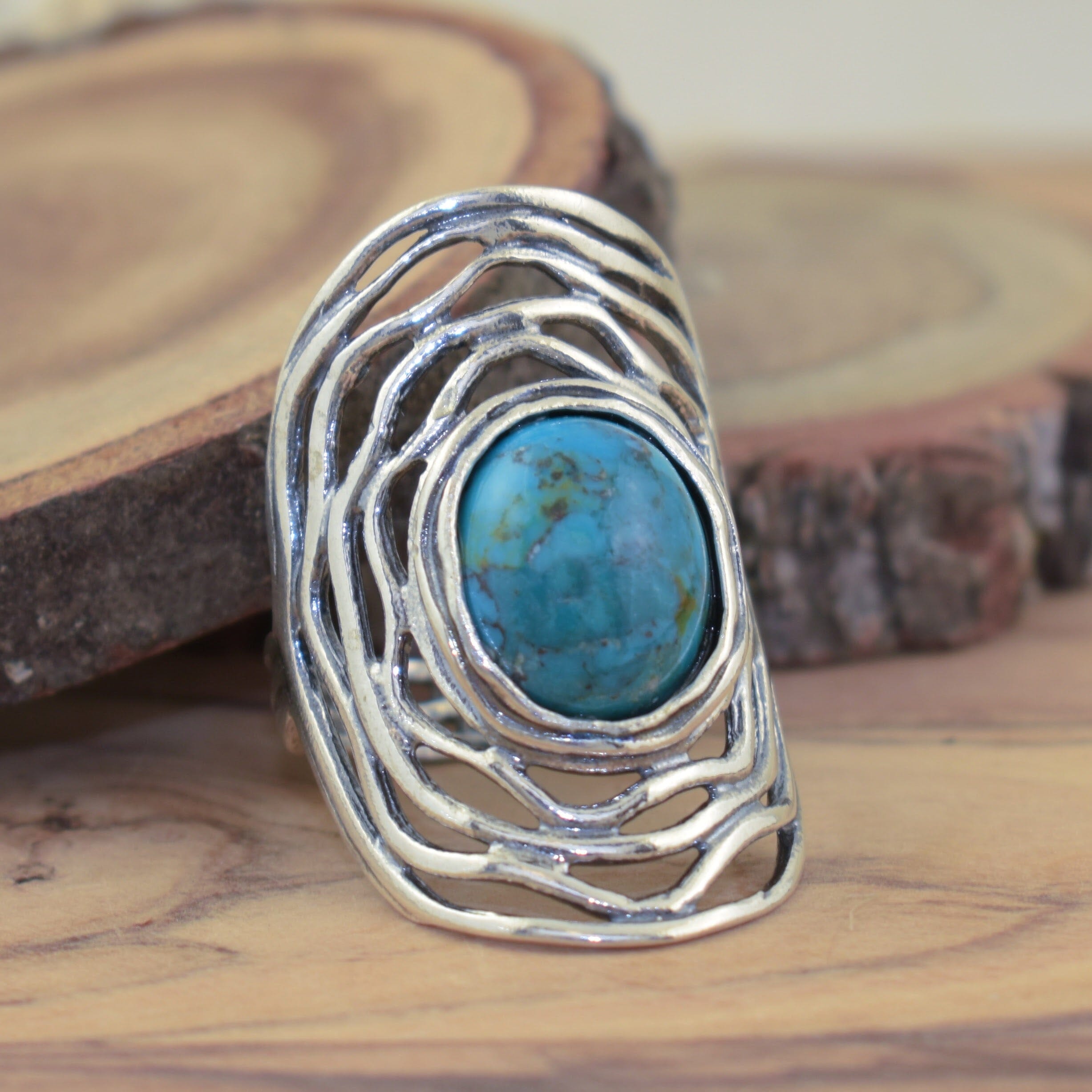 round reconstructed turquoise bezel set in a handcrafted sterling silver ring