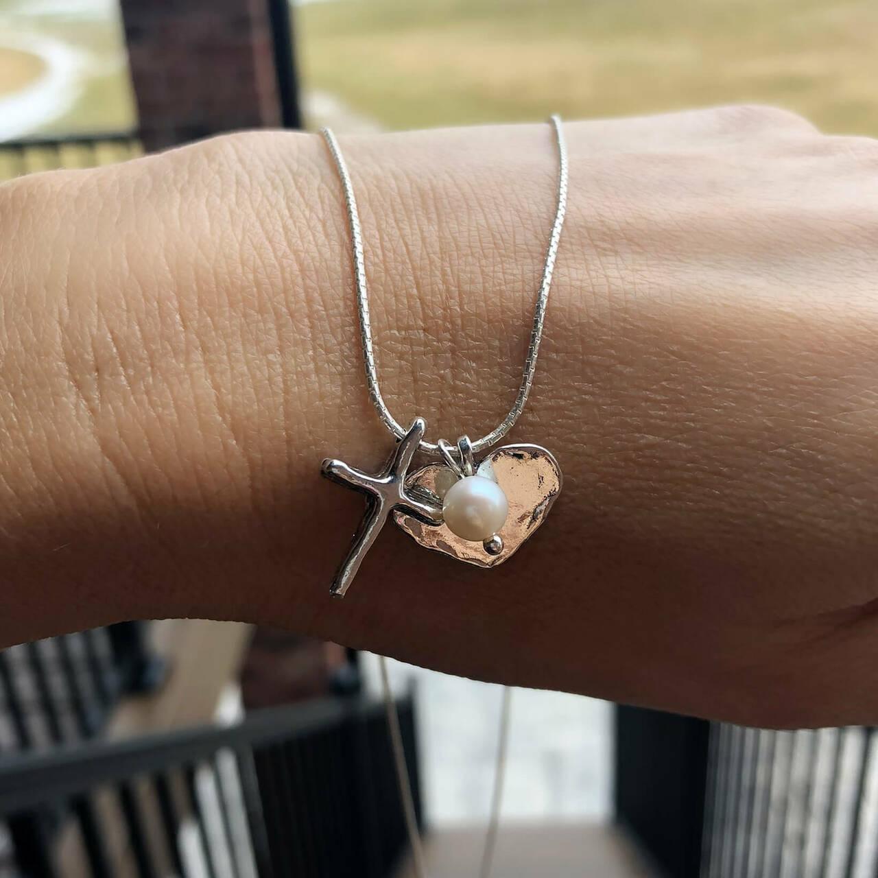 Sterling silver and pearl necklace with cross and heart pendants