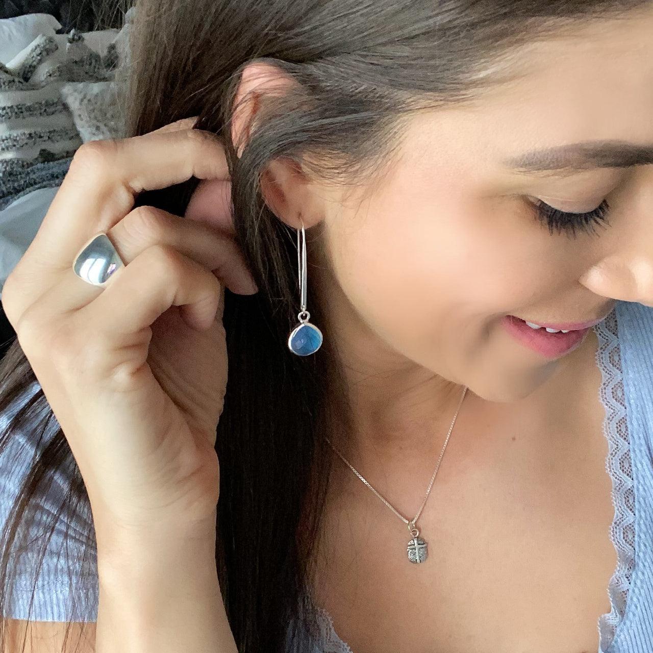 Elongated dangle earrings with round blue stone and sterling silver