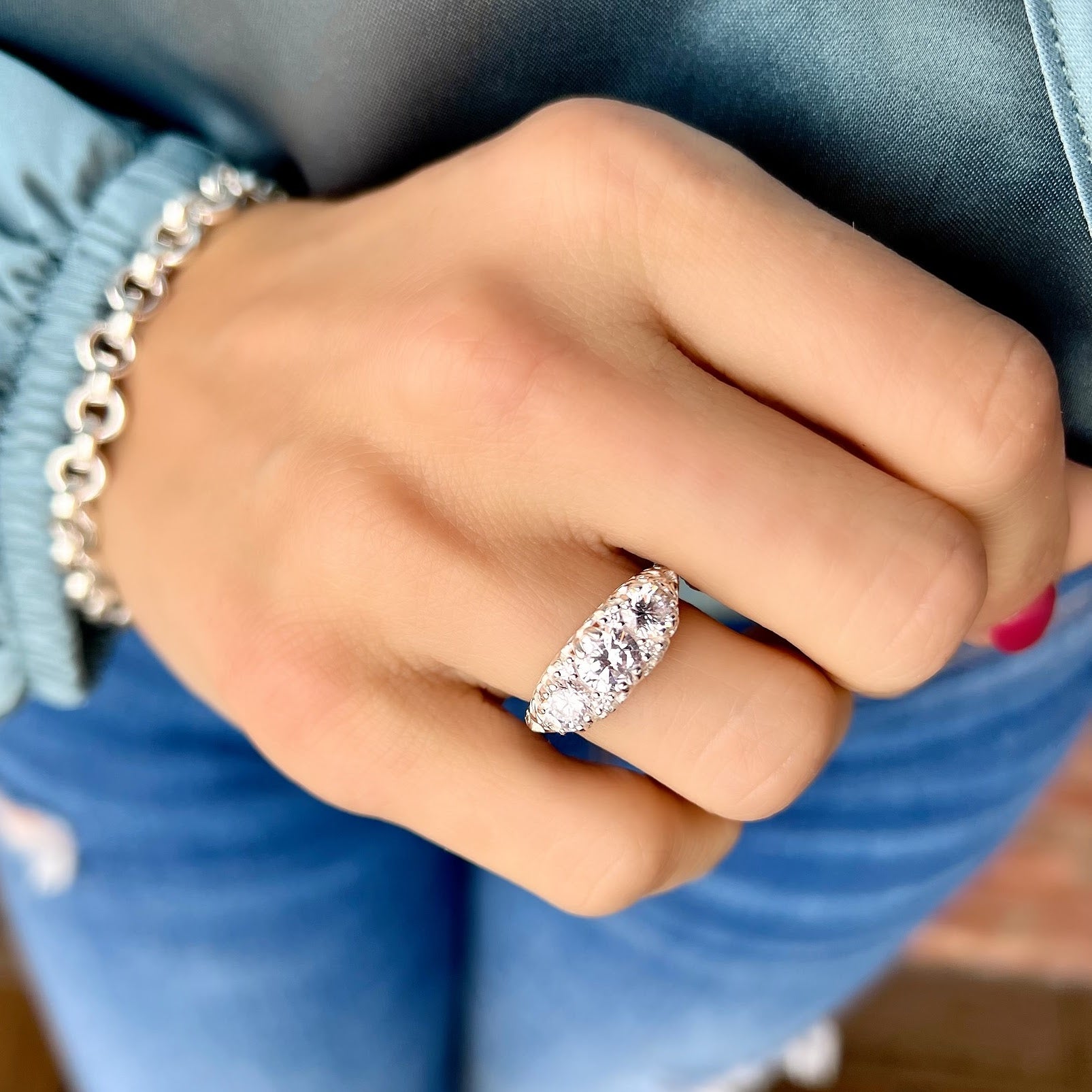 vintage style ring with three cubic zirconia and a scroll design