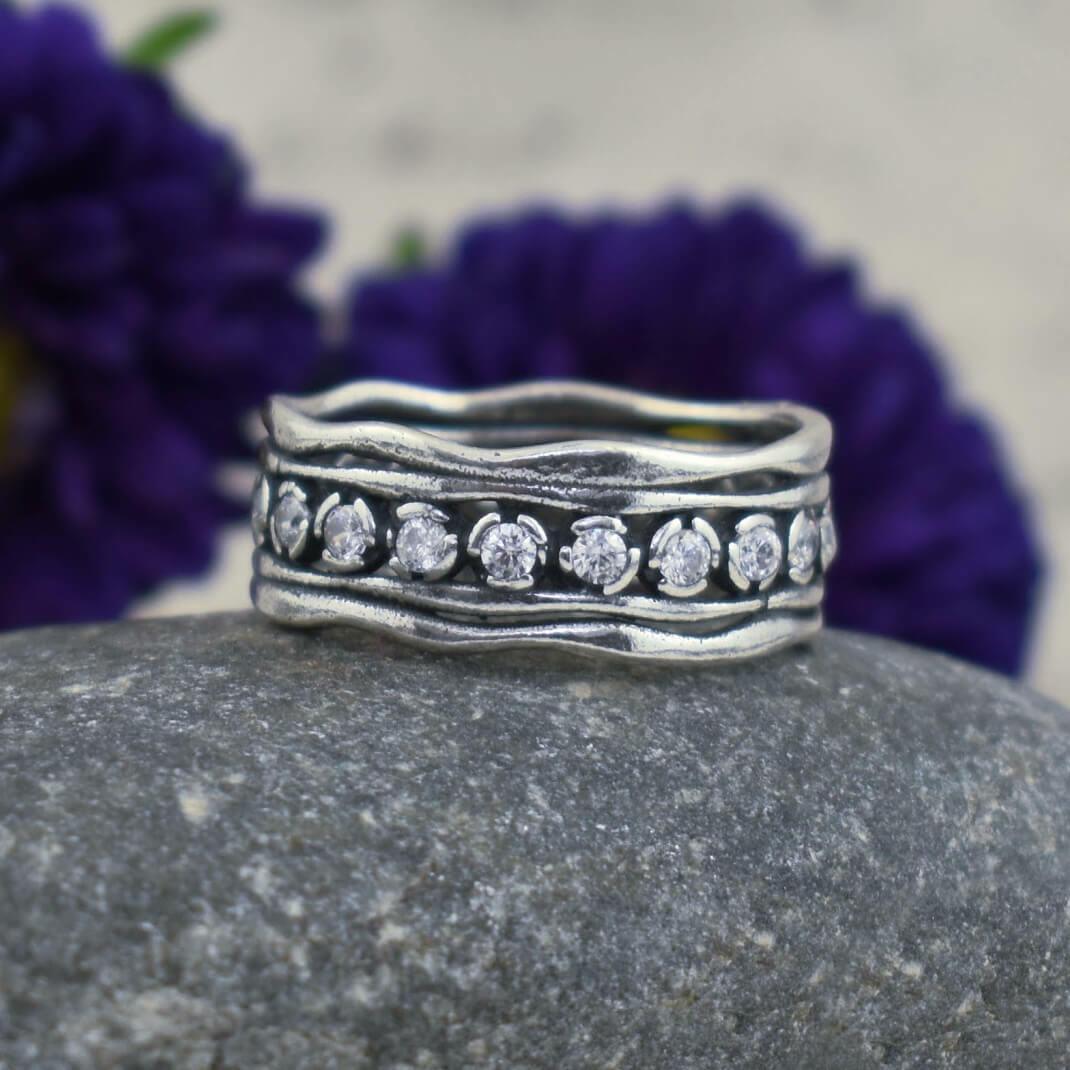 Designer wavy-edged band with CZ